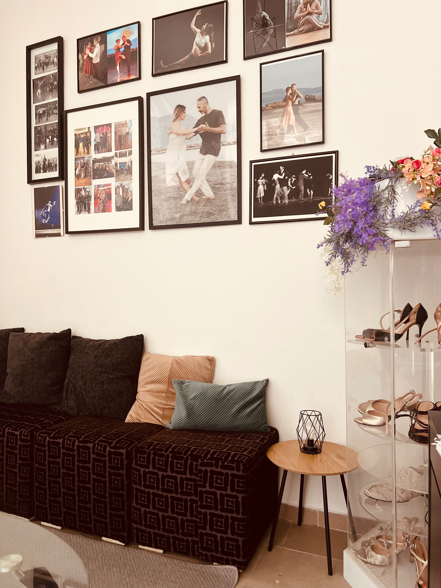 Dance Flame lounge corner with framed dance photos, sofa and shoe display