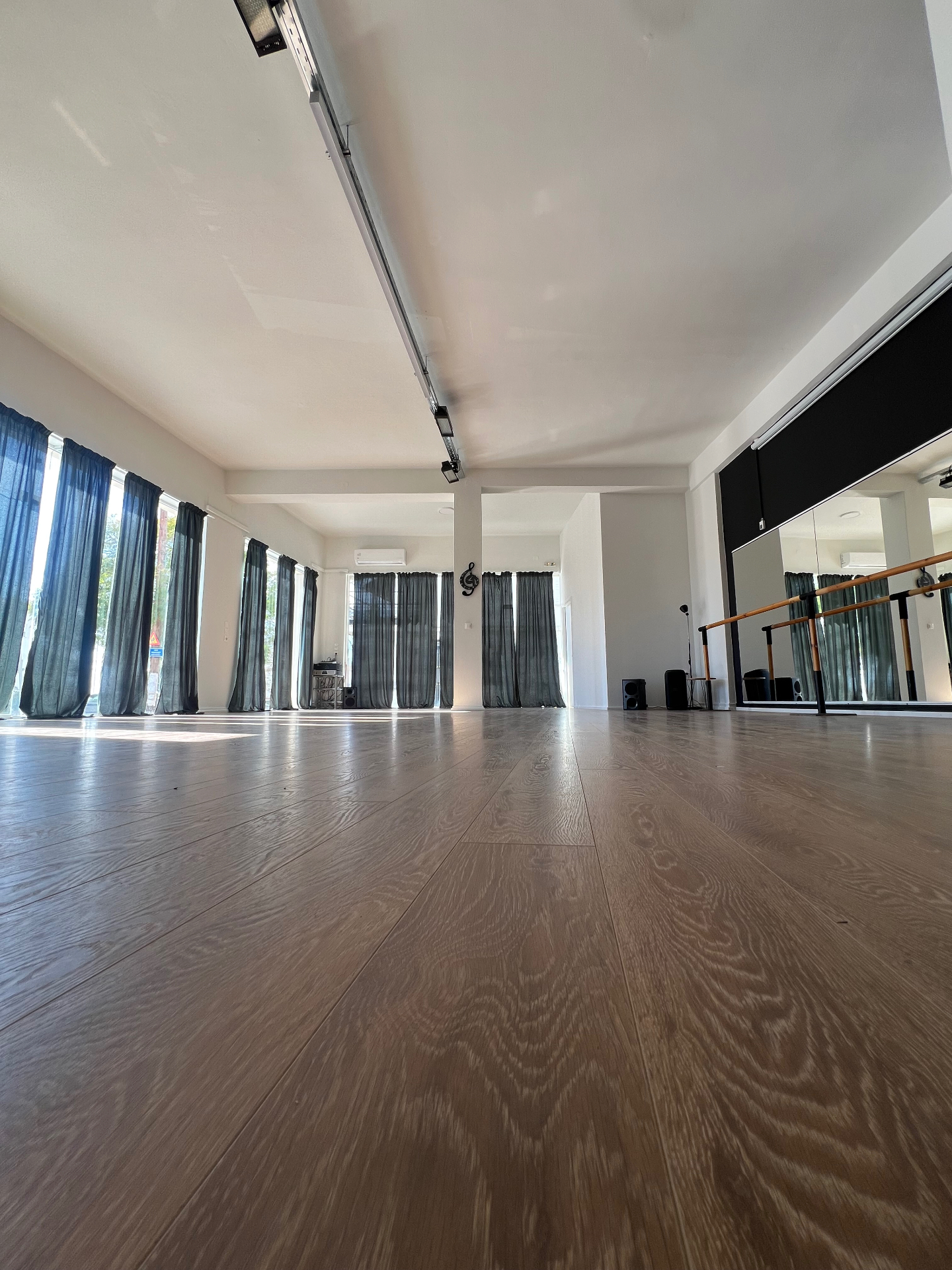 Dance Flame main hall with wooden floor, mirrors and ballet barre